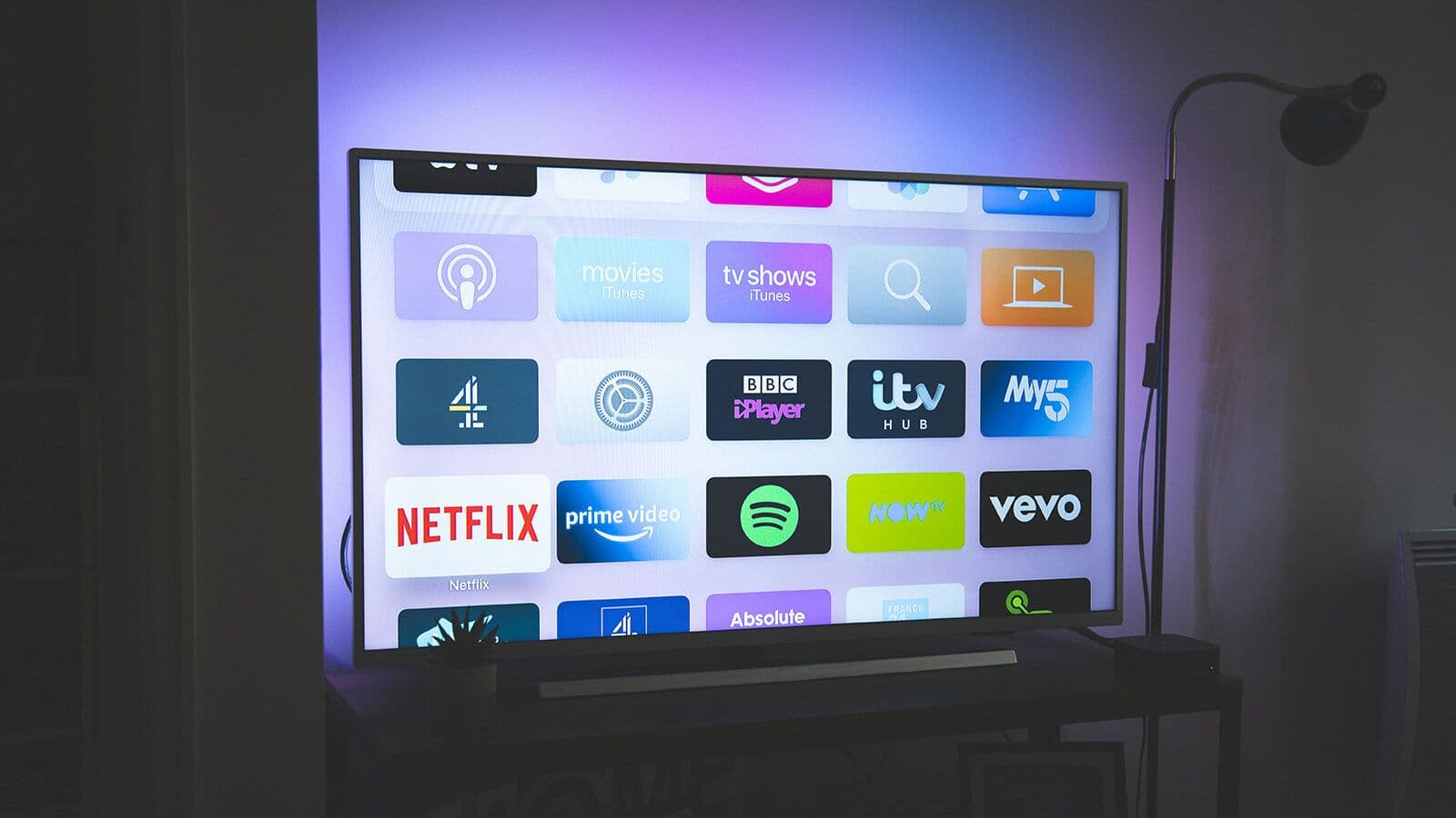 A person watching a gripping miniseries on a streaming platform in a dark room